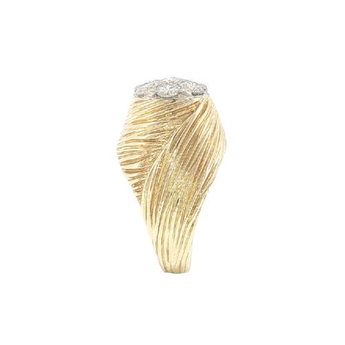 fig 4. A vintage 18ct yellow gold ring featuring a central round cluster of seven diamonds surrounded by a wide, textured gold border.