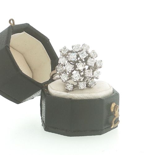 fig 1. A vintage 1970s 18ct white gold cocktail ring featuring a domed cluster setting filled with round brilliant cut diamonds.
