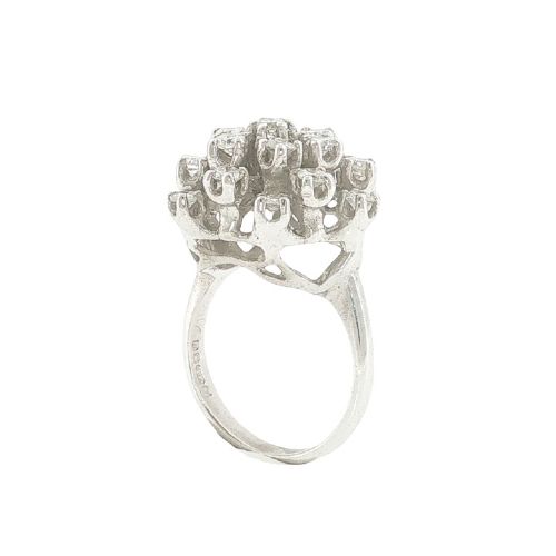fig 2. A vintage 1970s 18ct white gold cocktail ring featuring a domed cluster setting filled with round brilliant cut diamonds.