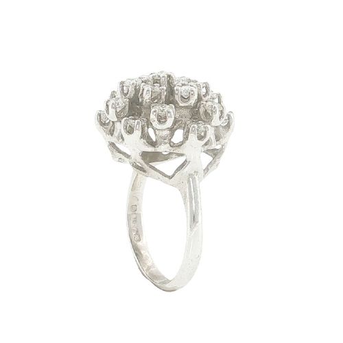 fig 3. A vintage 1970s 18ct white gold cocktail ring featuring a domed cluster setting filled with round brilliant cut diamonds.