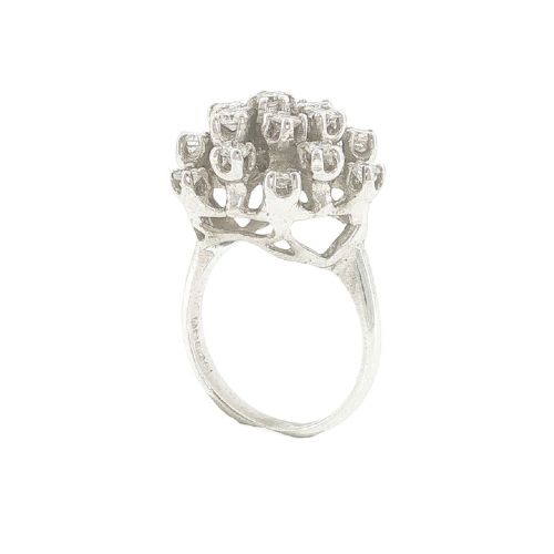 fig 4. A vintage 1970s 18ct white gold cocktail ring featuring a domed cluster setting filled with round brilliant cut diamonds.