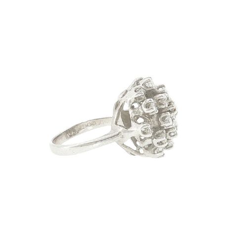 A vintage 1970s 18ct white gold cocktail ring featuring a domed cluster setting filled with round brilliant cut diamonds. View VI