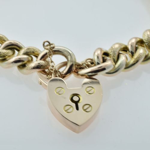 An antique 9ct gold curb link bracelet featuring half-engraved links, a heart-shaped padlock clasp, and an attached safety chain. View III