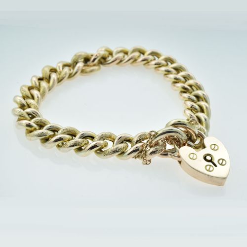 An antique 9ct gold curb link bracelet featuring half-engraved links, a heart-shaped padlock clasp, and an attached safety chain. View V