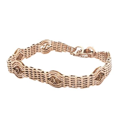fig 1. An antique 9ct rose gold gate link bracelet featuring openwork scroll panels, a heart padlock clasp, and a safety chain.