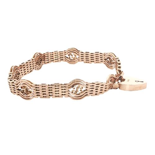 fig 2. An antique 9ct rose gold gate link bracelet featuring openwork scroll panels, a heart padlock clasp, and a safety chain.
