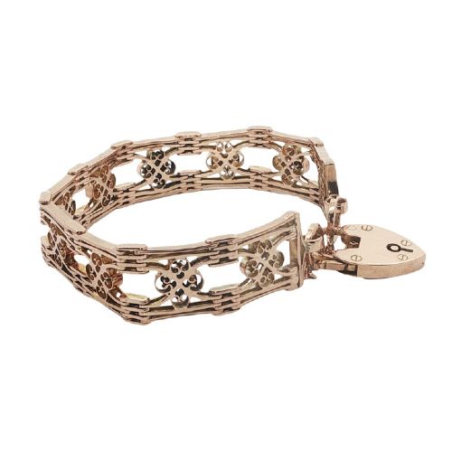 fig 2. An antique 9ct rose gold gate link bracelet featuring decorative openwork filigree panels and a heart-shaped padlock clasp.