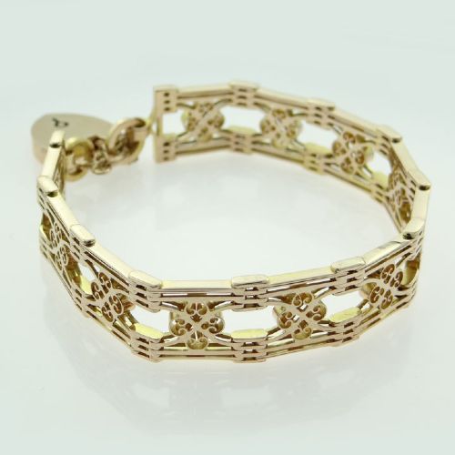 fig 1. An antique 9ct rose gold fancy gate link bracelet featuring pierced scrollwork panels and a heart padlock clasp with a safety chain.