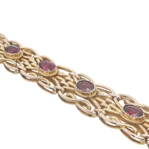 fig 1. An antique 9ct rose gold link bracelet featuring oval-cut almandine garnets set in ornate scrollwork links with a box clasp.