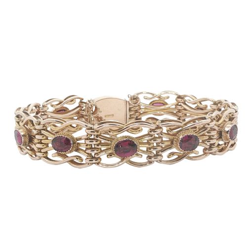 fig 2. An antique 9ct rose gold link bracelet featuring oval-cut almandine garnets set in ornate scrollwork links with a box clasp.