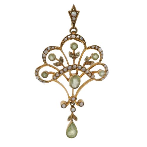 An openwork 15ct yellow gold Edwardian pendant set with small seed pearls and light green peridot gemstones with a central oval stone and hanging drop.