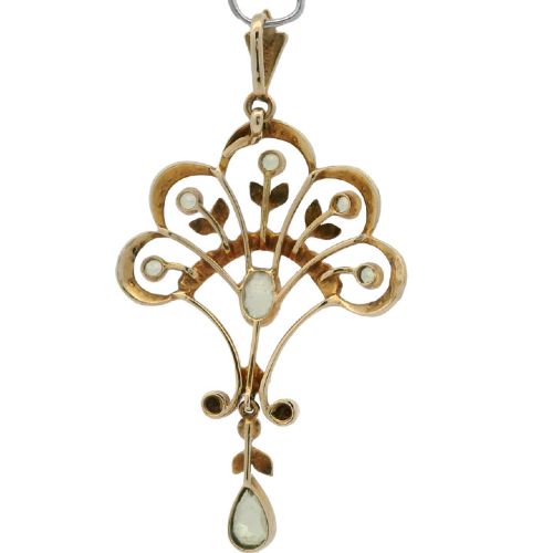 An openwork 15ct yellow gold Edwardian pendant set with small seed pearls and light green peridot gemstones with a central oval stone and hanging drop. View VI