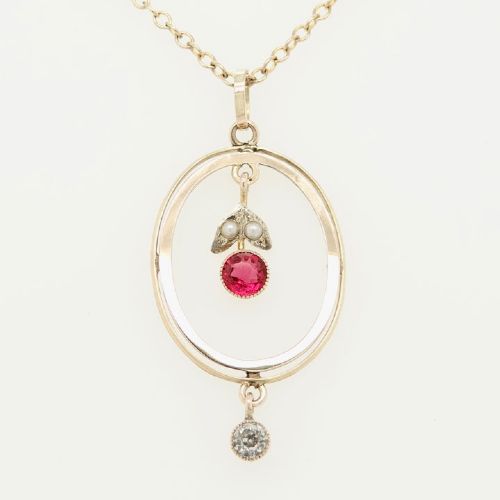 An open oval 9ct yellow gold pendant featuring an inner suspended drop set with two seed pearls and a pink paste stone, finished with an articulated clear paste drop below.