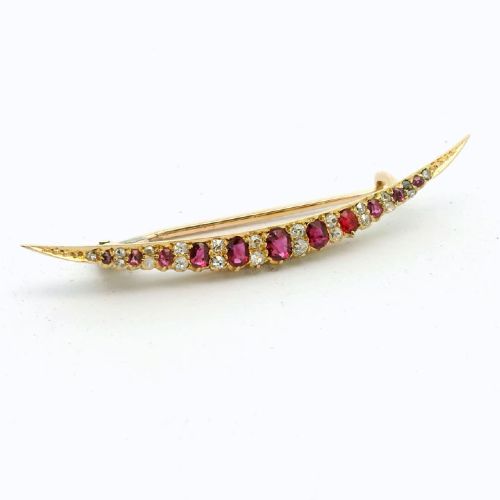 fig 1. An antique late Victorian 15ct gold crescent brooch set with a graduated row of faceted red rubies and small white diamonds.