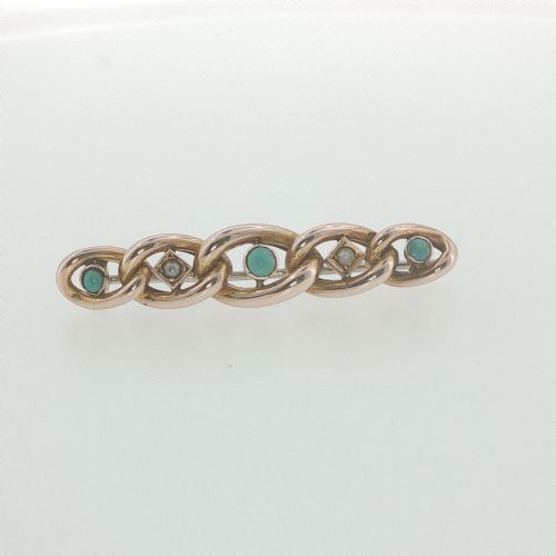 fig 1. An antique 9ct rose gold bar brooch with curb links set with turquoise cabochons and seed pearls resting in a fitted presentation box.