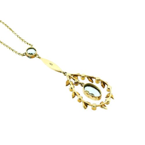 fig 3. An Edwardian 15ct gold lavalier necklace featuring a round aquamarine top stone, a seed-pearl-set vertical bar, and a floral garland pendant surrounding a suspended oval aquamarine.
