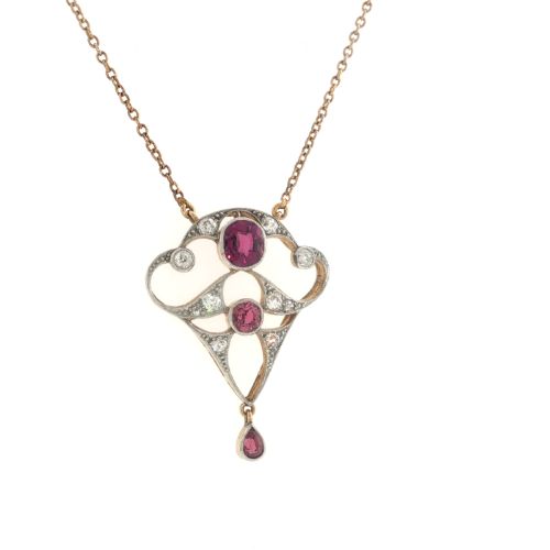 fig 3. An Edwardian openwork 15ct gold and silver-topped pendant set with round rubies, diamond accents, and a pear-cut ruby drop on a gold chain.