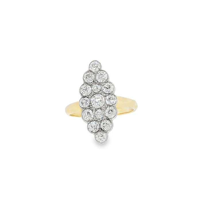 An Edwardian navette cluster ring featuring multiple old cut diamonds set in platinum with an 18ct yellow gold band.
