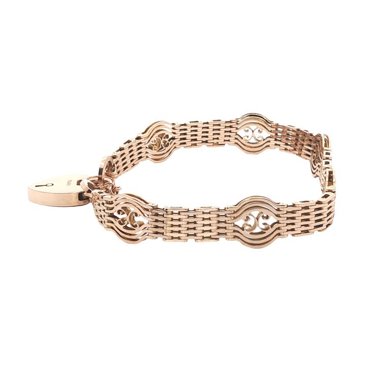 An antique 9ct rose gold gate link bracelet featuring openwork scroll panels, a heart padlock clasp, and a safety chain. View VI