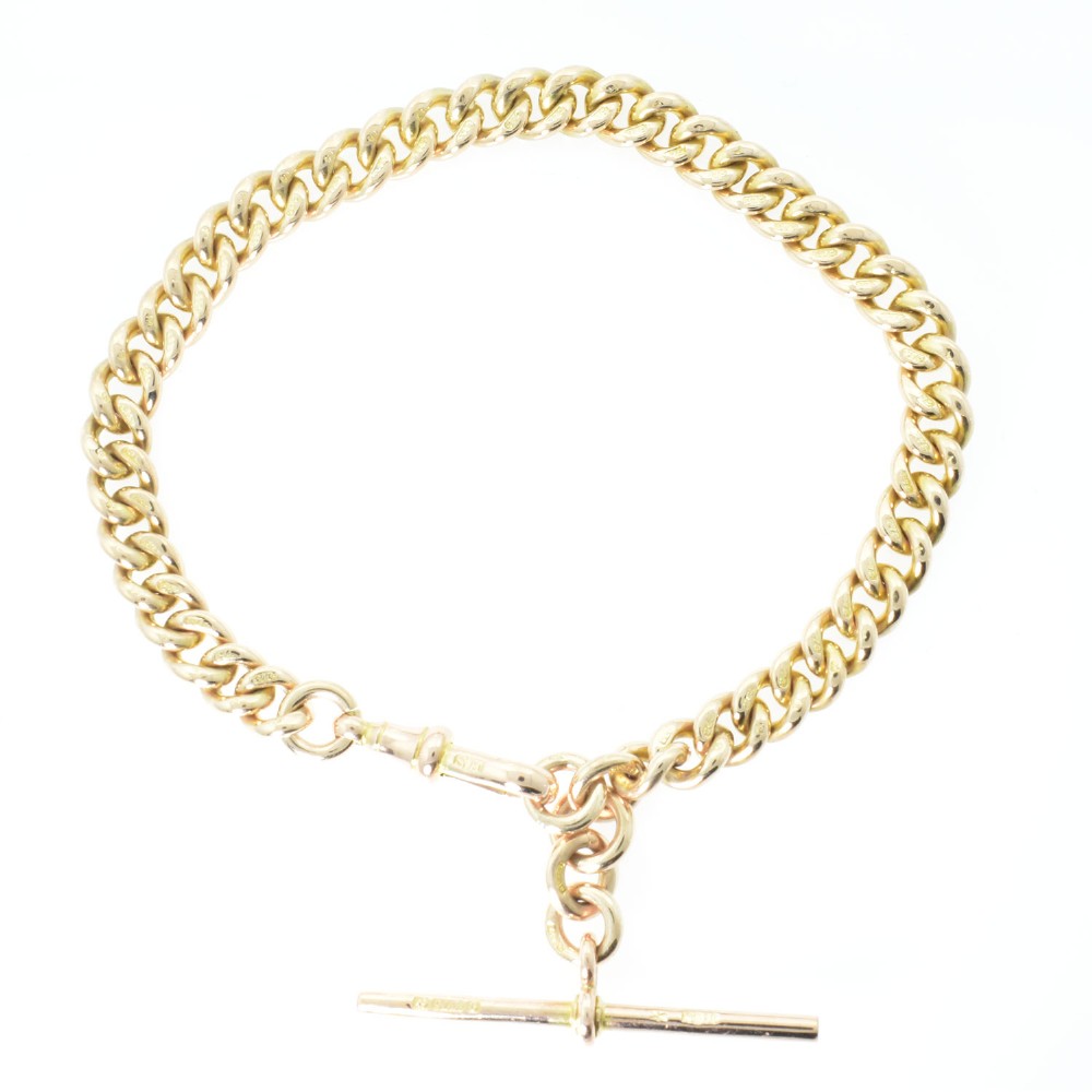 An antique 9ct rose gold Albert chain bracelet featuring uniform curb links, a suspended T-bar pendant, and a swivel clasp.