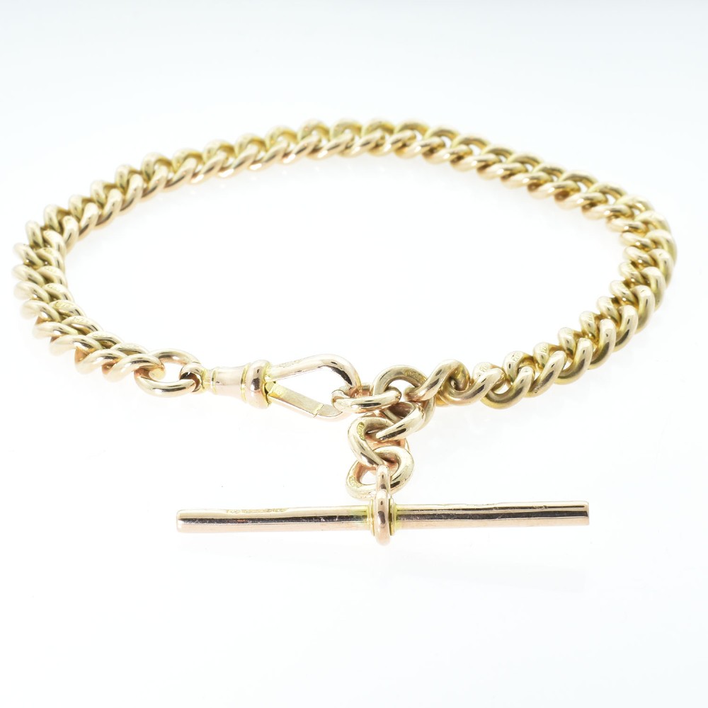An antique 9ct rose gold Albert chain bracelet featuring uniform curb links, a suspended T-bar pendant, and a swivel clasp. View II