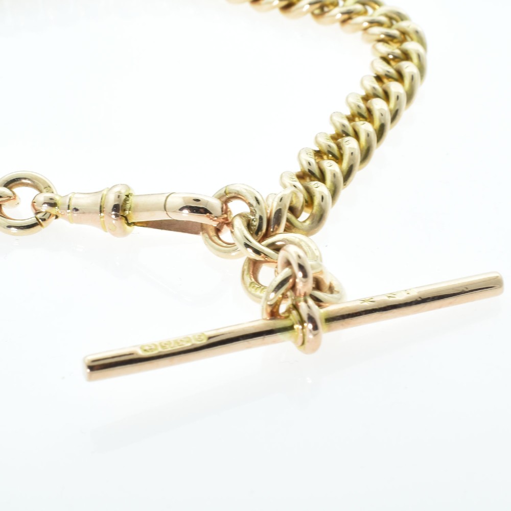 An antique 9ct rose gold Albert chain bracelet featuring uniform curb links, a suspended T-bar pendant, and a swivel clasp. View IV