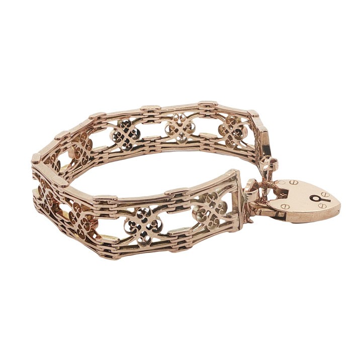 An antique 9ct rose gold gate link bracelet featuring decorative openwork filigree panels and a heart-shaped padlock clasp. View III