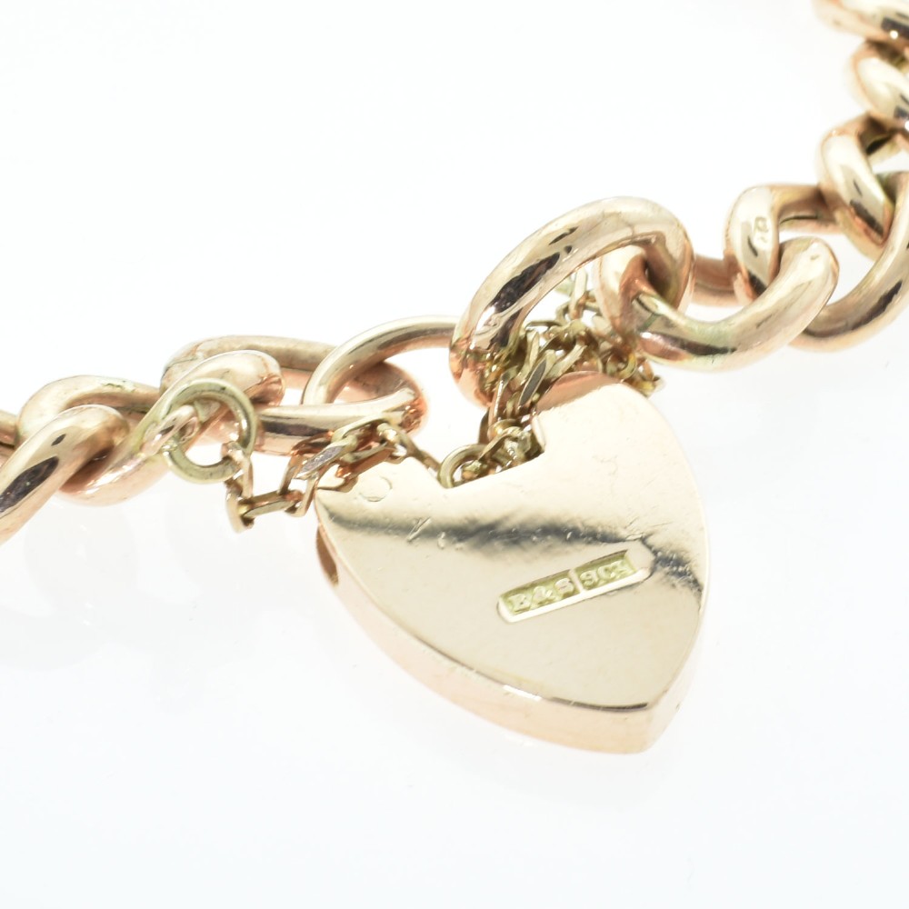 An antique rose gold curb link bracelet featuring alternating plain and engraved links fastened with a heart-shaped padlock clasp. View IV