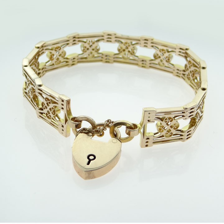 An antique 9ct rose gold fancy gate link bracelet featuring pierced scrollwork panels and a heart padlock clasp with a safety chain. View III