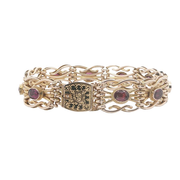 An antique 9ct rose gold link bracelet featuring oval-cut almandine garnets set in ornate scrollwork links with a box clasp. View VI