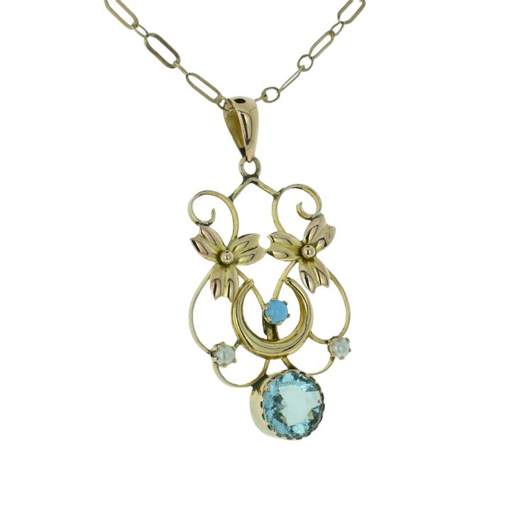 An antique 9ct rose gold openwork pendant featuring a crescent moon motif set with turquoise, seed pearl accents, and a central round faceted blue topaz drop. View II
