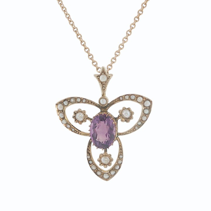 An Edwardian 9ct gold openwork pendant featuring a central oval amethyst surrounded by delicate seed pearls on a fine chain. View II