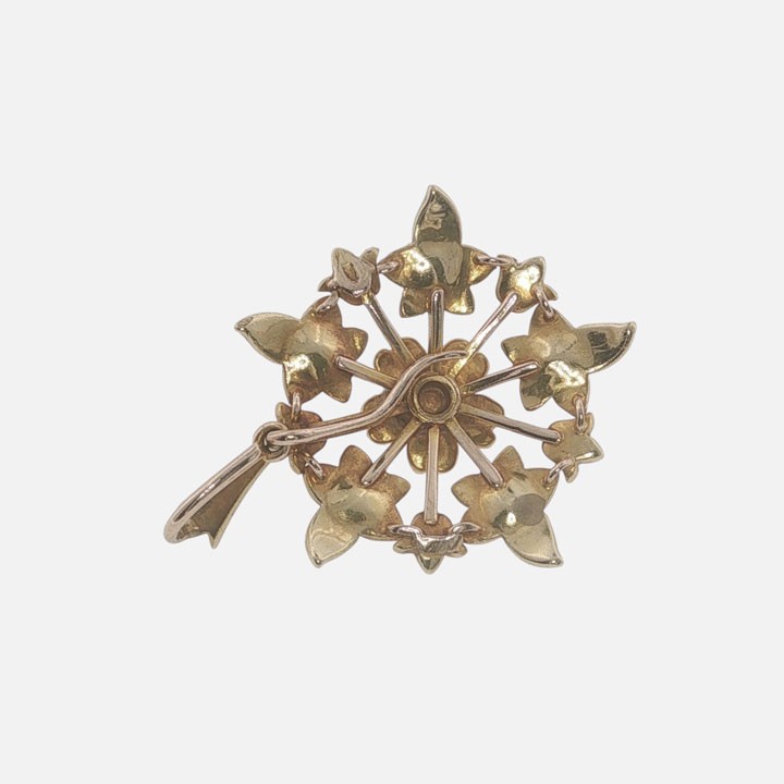 A late Victorian 15ct gold starburst pendant set with central and accent seed pearls forming a floral motif. View IV