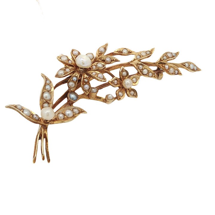 An antique 15ct yellow gold floral spray brooch featuring articulated flowers and leaves set with seed pearls, attached to a safety chain. View II