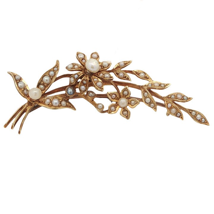 An antique 15ct yellow gold floral spray brooch featuring articulated flowers and leaves set with seed pearls, attached to a safety chain. View III