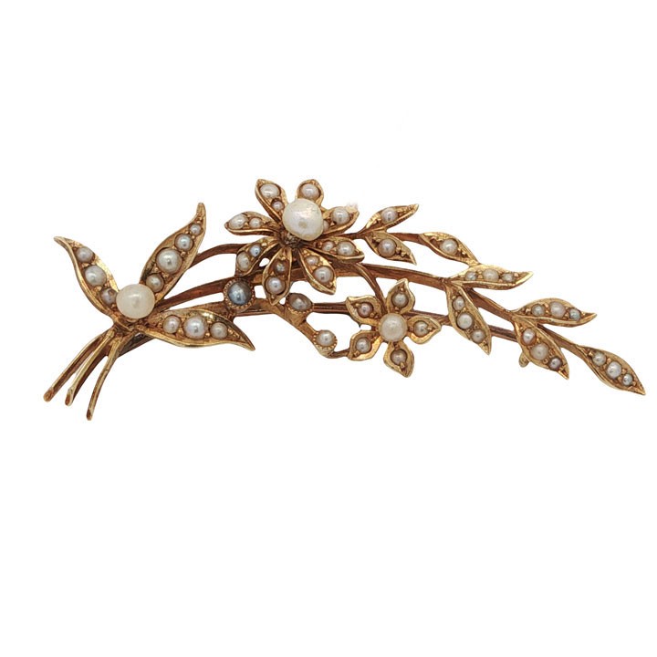 An antique 15ct yellow gold floral spray brooch featuring articulated flowers and leaves set with seed pearls, attached to a safety chain. View IV