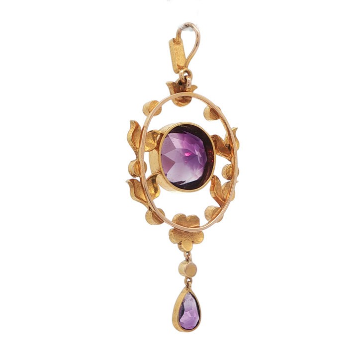 An openwork 15ct yellow gold oval pendant featuring a central round faceted amethyst framed by seed pearl leaf motifs, with a pear-cut amethyst drop suspended below. View IV