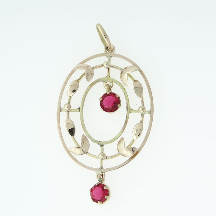 An oval 9ct yellow and rose gold openwork pendant featuring stylized leaf motifs and two round red simulated rubies. View III