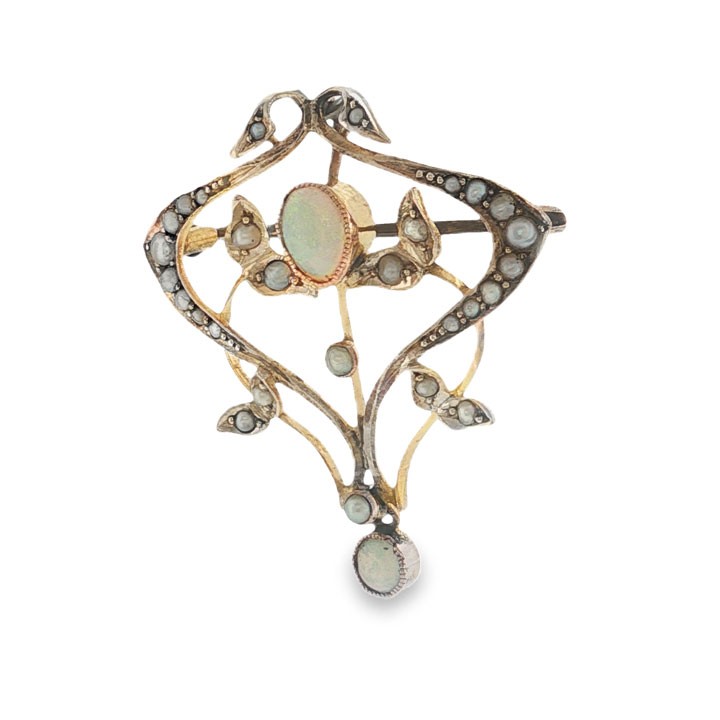 An Edwardian 9ct yellow gold openwork pendant featuring a central oval cabochon opal framed by leaf motifs set with seed pearls. View IV