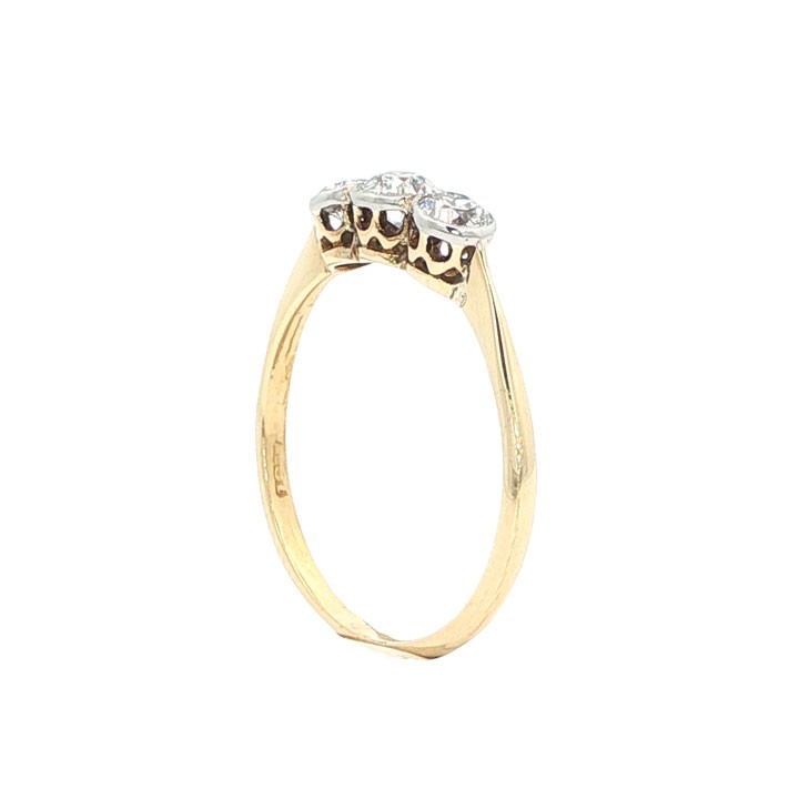 An antique 18ct yellow gold ring set with three round old-cut diamonds in a horizontal trilogy setting. View V