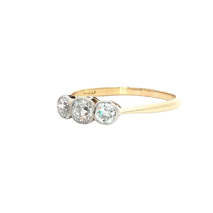 An antique 18ct yellow gold ring set with three round old-cut diamonds in a horizontal trilogy setting. View VI