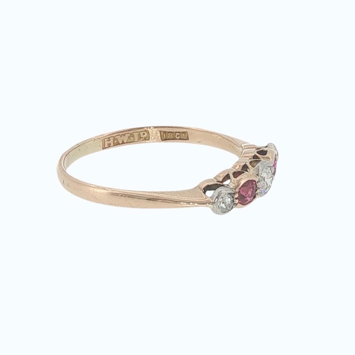 An antique 18ct yellow gold ring featuring a five-stone setting with alternating rubies and diamonds. View V
