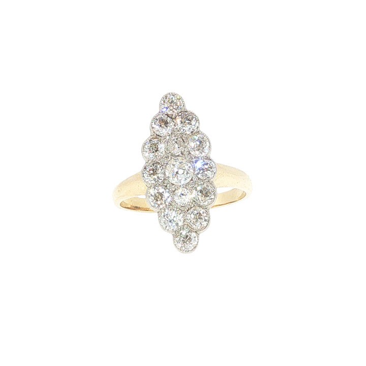 An Edwardian navette cluster ring featuring multiple old cut diamonds set in platinum with an 18ct yellow gold band.