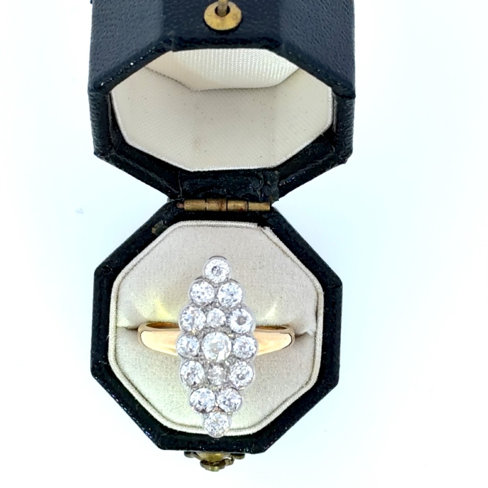 An Edwardian navette cluster ring featuring multiple old cut diamonds set in platinum with an 18ct yellow gold band. View II