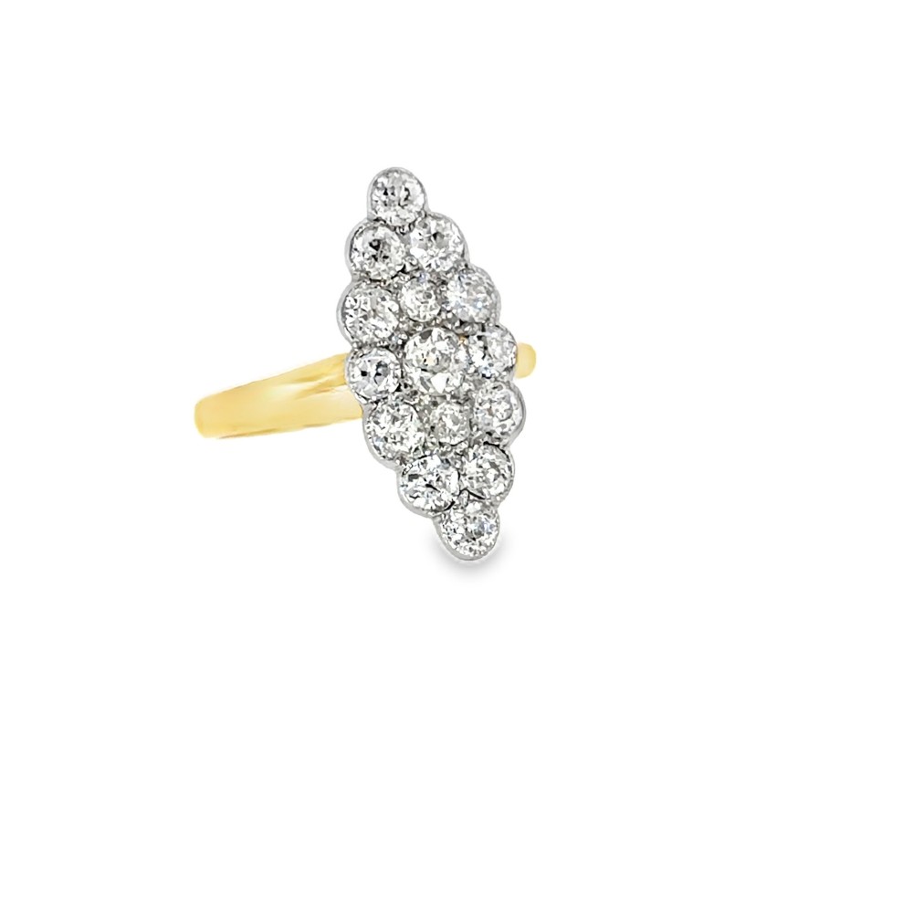 An Edwardian navette cluster ring featuring multiple old cut diamonds set in platinum with an 18ct yellow gold band. View VI