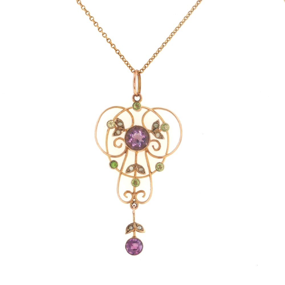 An openwork 9ct gold Edwardian pendant set with round amethysts, peridots, and seed pearls suspended on a fine chain. View II