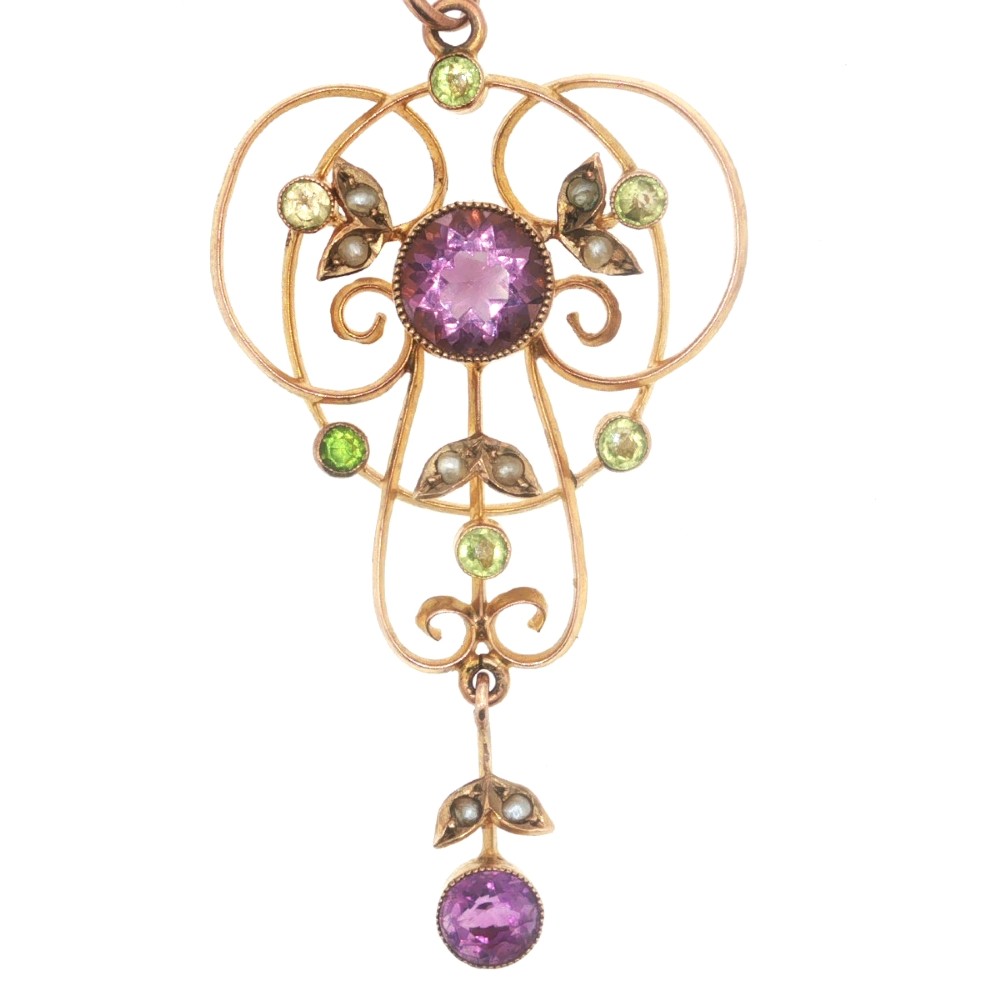 An openwork 9ct gold Edwardian pendant set with round amethysts, peridots, and seed pearls suspended on a fine chain. View VI