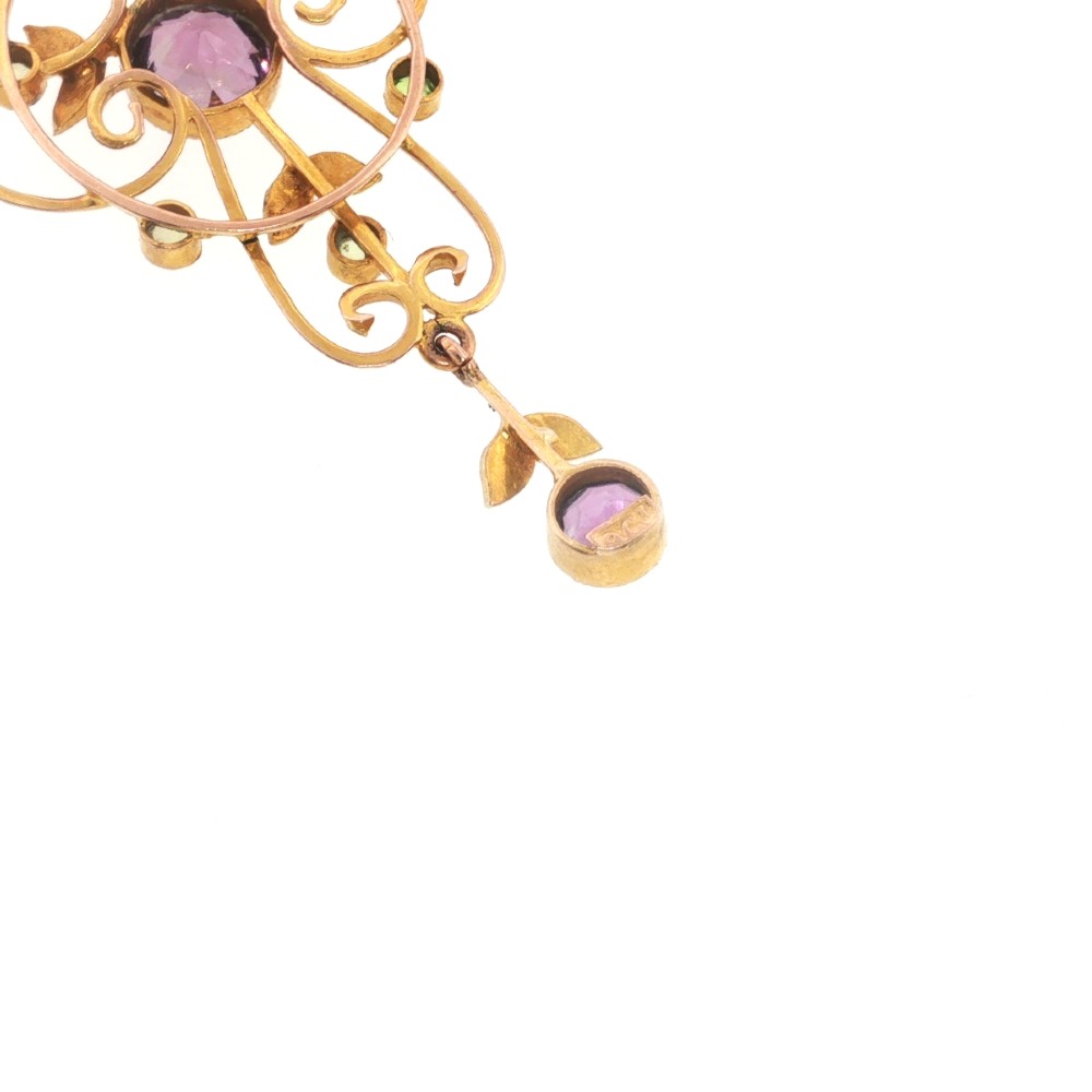 An openwork 9ct gold Edwardian pendant set with round amethysts, peridots, and seed pearls suspended on a fine chain. View VII