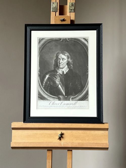 fig 2. A framed monochrome mezzotint print depicting a bust-length portrait of Oliver Cromwell in armour set within an oval border.