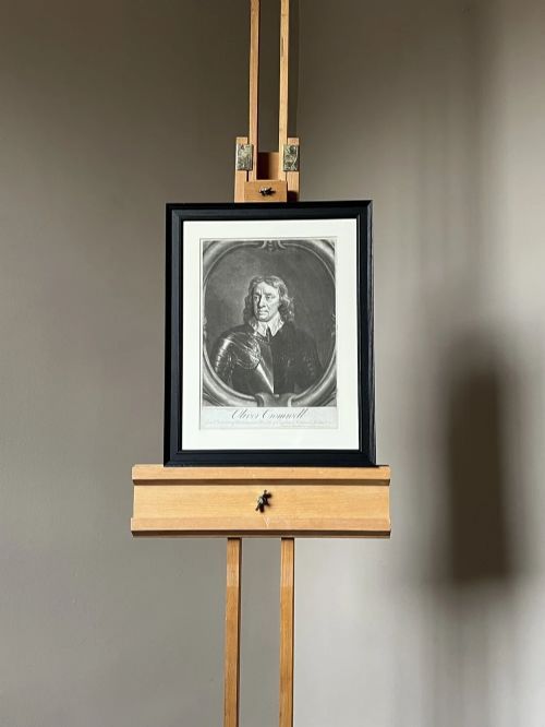 fig 3. A framed monochrome mezzotint print depicting a bust-length portrait of Oliver Cromwell in armour set within an oval border.